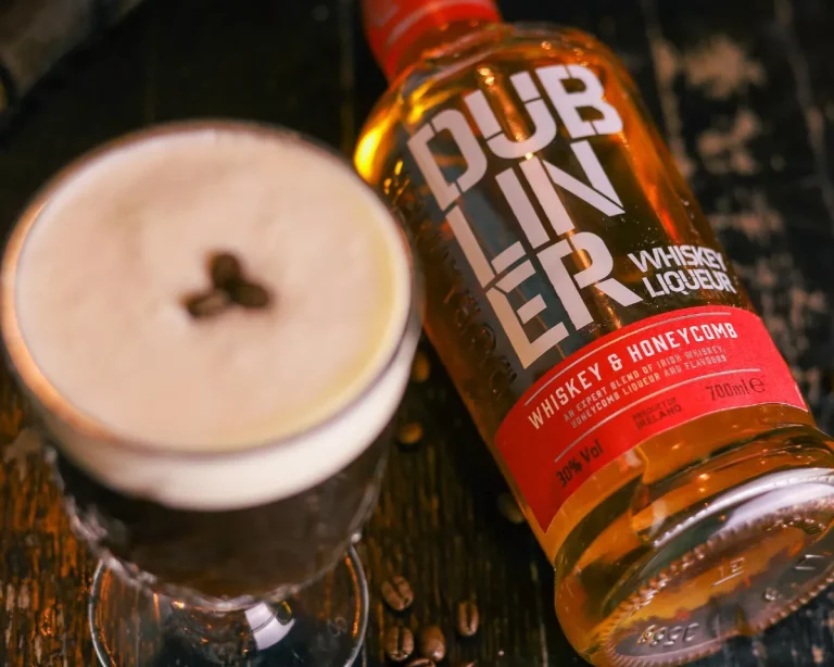A bottle of Dubliner Whiskey and a full glass